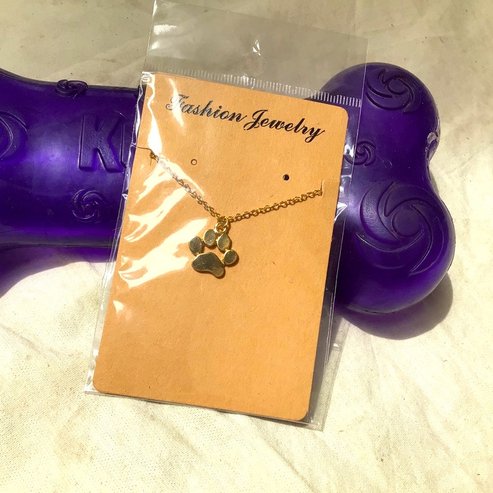 Gold colored paw necklace.🐾